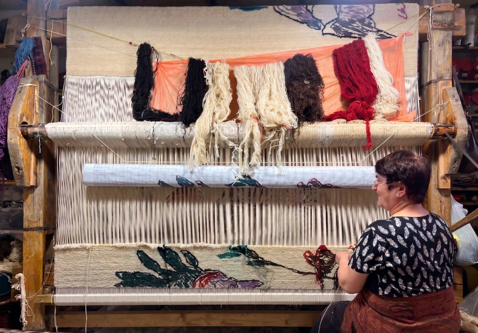 Lena Arakelyan weaving “Meghri, The Earth Rises.” (Photo: Melika Safaei / CivilNet)
