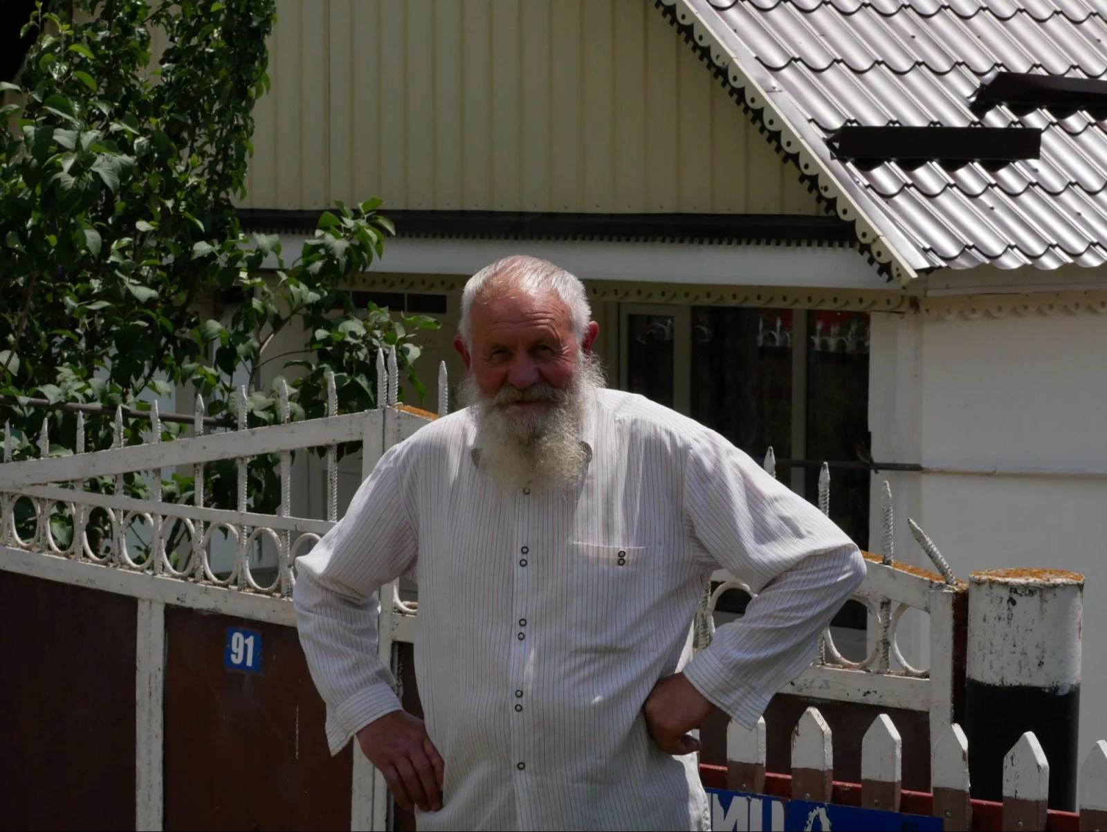 Mikhail in front of his home in Fioletovo.