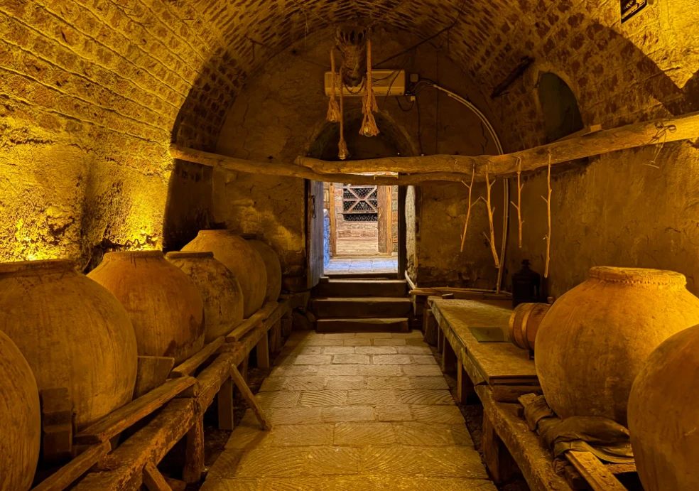 The wine cellar in Hayk and Nelly's house-museum, with traditional karas clay vessels used for fermentation. 