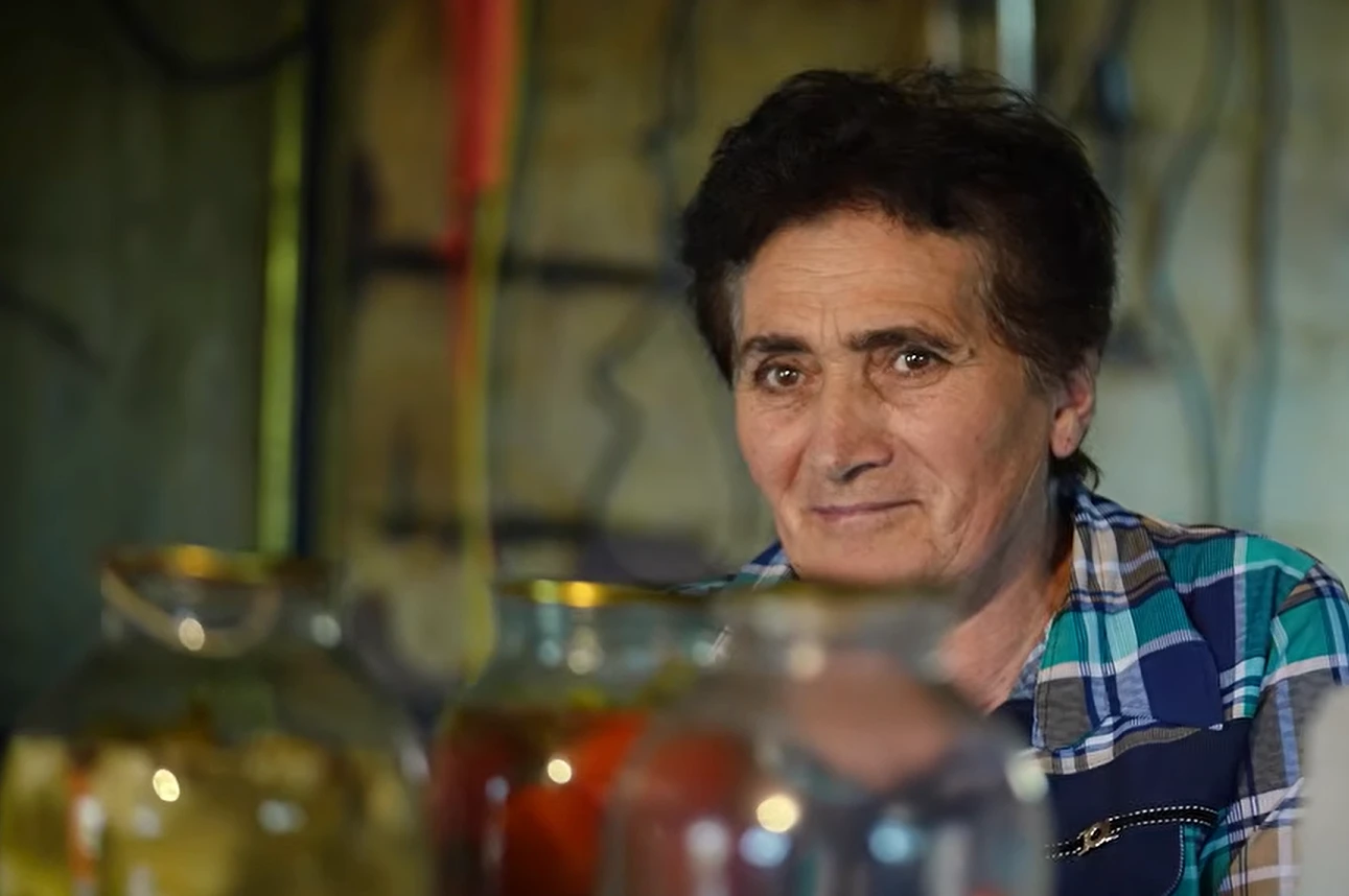 Margarit Khchoyan gets ready to open jars of her homemade preserves for the CivilNet guests.